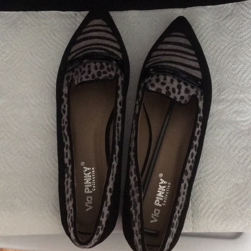 Pair of flat shoes with low black heel.